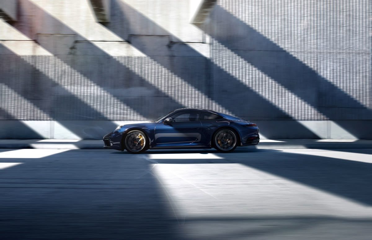 Blue sports car in dramatic light and shadow